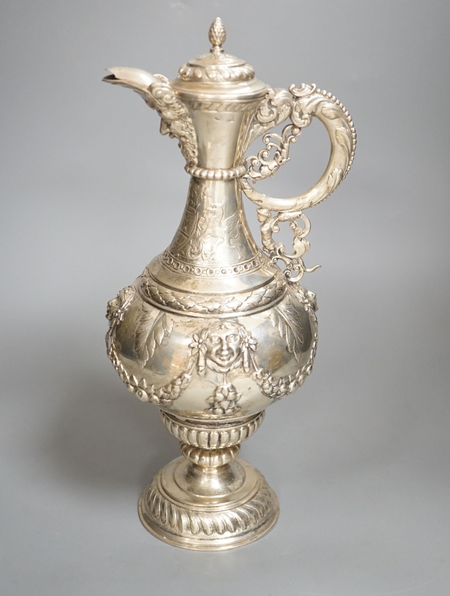 A 19th century Continental white metal wine ewer, embossed with swags and masks, height 29.9cm, 16.5oz.